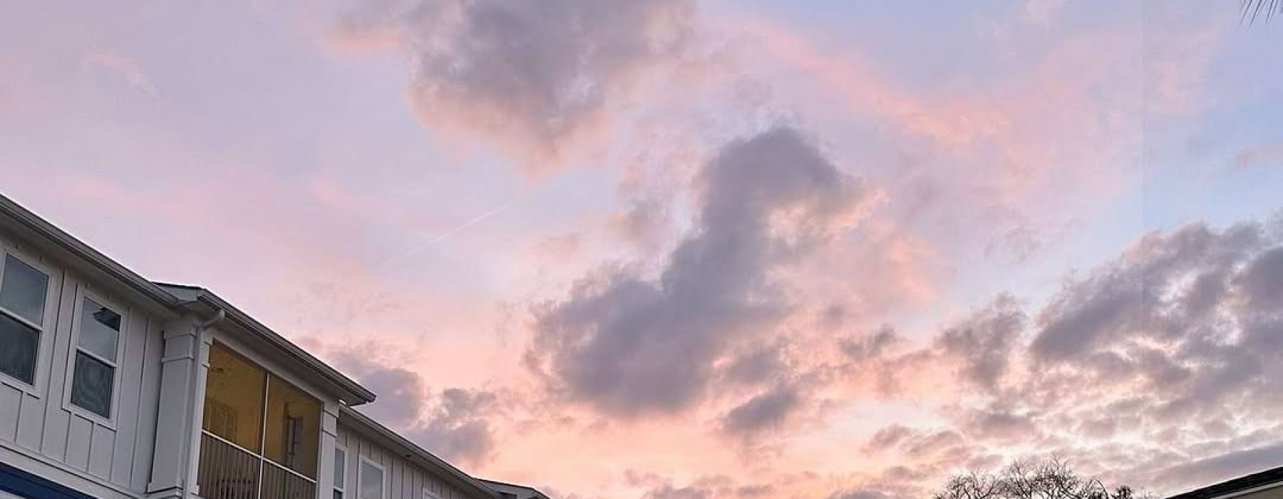 post of a sunset behind a building