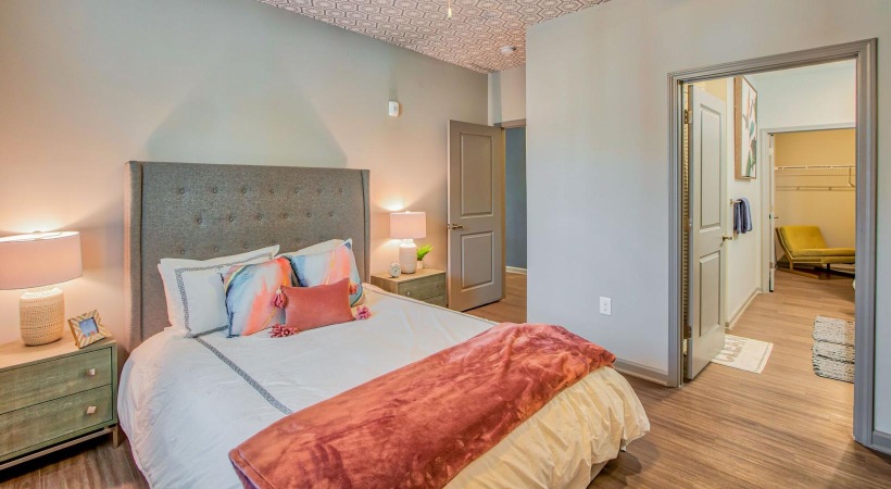 a bedroom with a bed and a fan