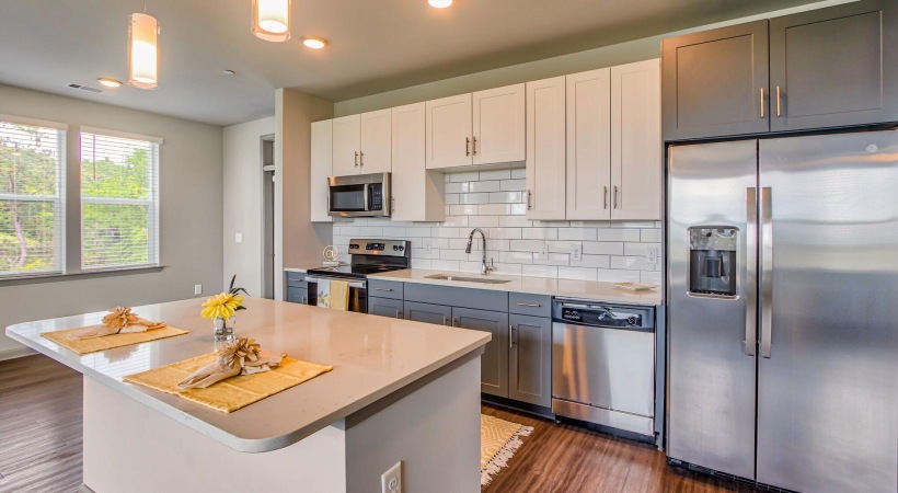 a kitchen with white cabinets and a kitchen island