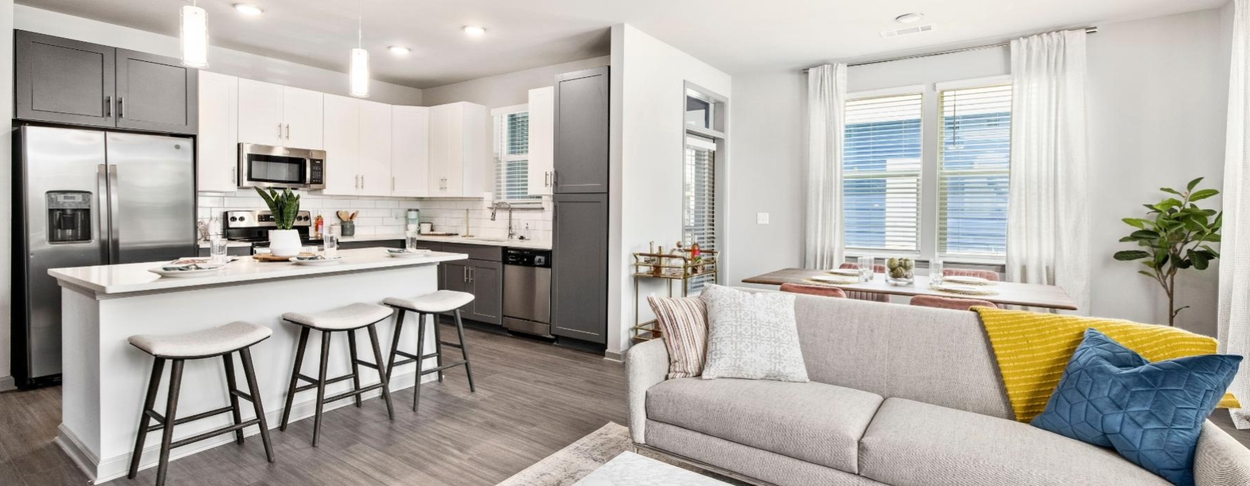 a kitchen and living area with a couch and a table