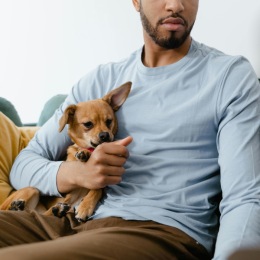a man holding a dog