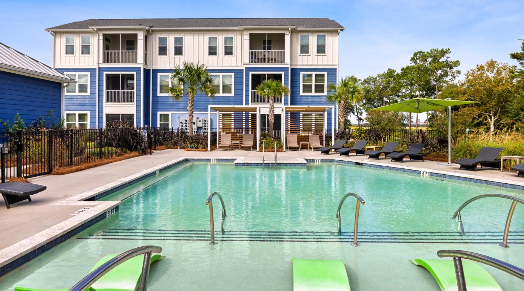 a pool in front of a blue building