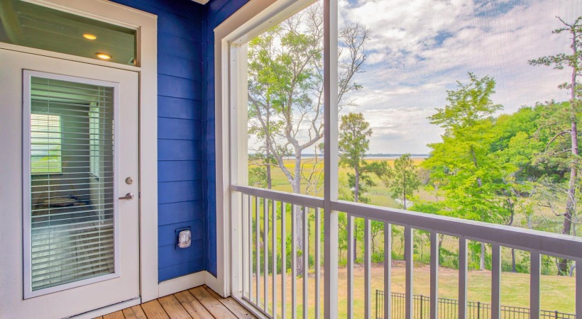 a balcony with a railing and trees