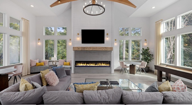 a lounge room with couches and a fireplace