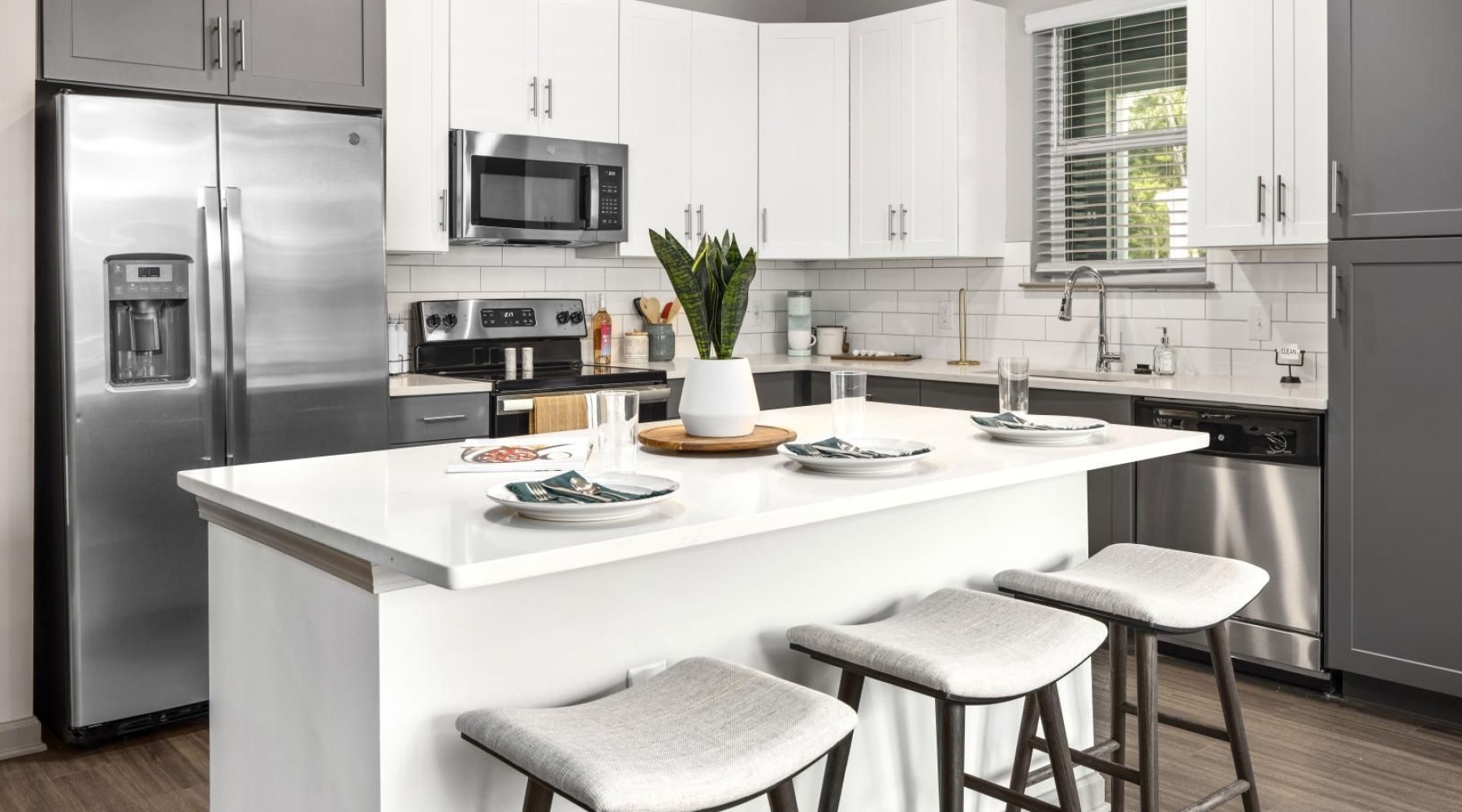 a kitchen with white cabinets and a kitchen island